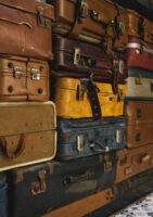Yellow suitcase in stack of suitcases